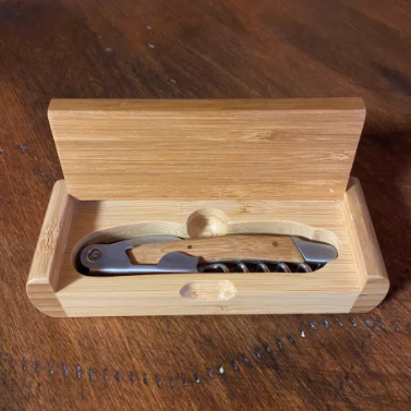 wooden box with a wine opener