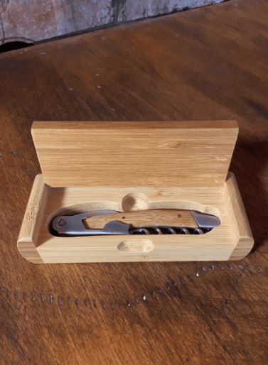 wooden box with a wine opener