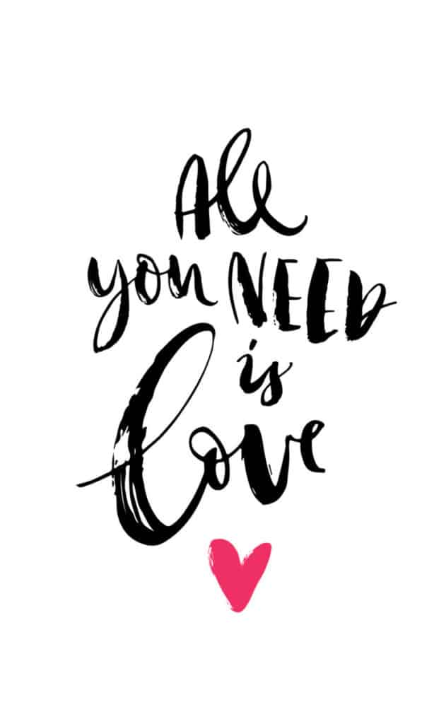 The "All You Need Is Love" product showcases a white background adorned with the handwritten phrase "All you need is love" in black script, where the word "love" stands out larger and bolder. Beneath this text lies a small, bright pink heart.
