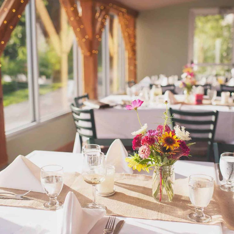 Tables at a wedding set with wildflowers