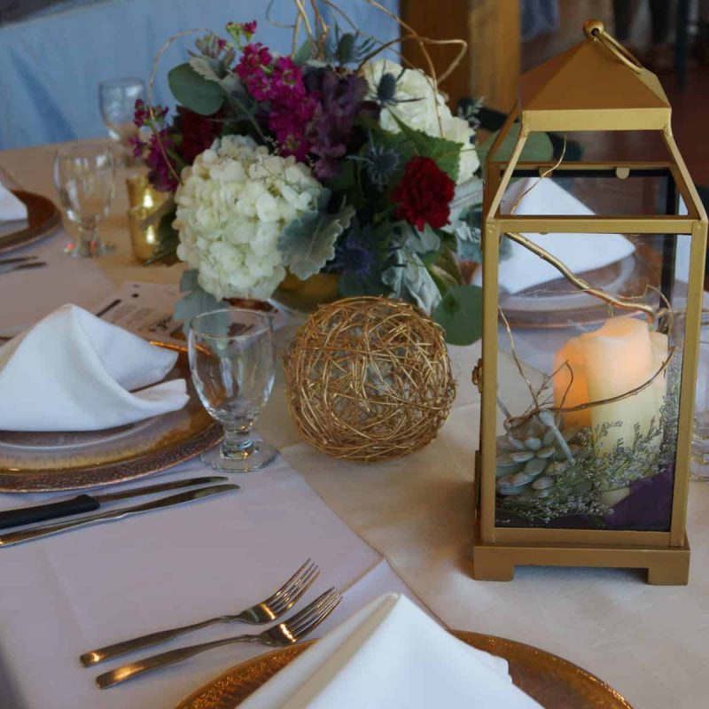 Tables at a wedding set with rustic decorations and roses